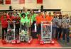 The winning alliance of (left to right) Sachem High School Team #263 “Sachem Aftershock,” Westhampton Beach High School Team #3171 “Hurricanes” and Hicksville High School Team #1468 “J-Birds” is joined by event referees.